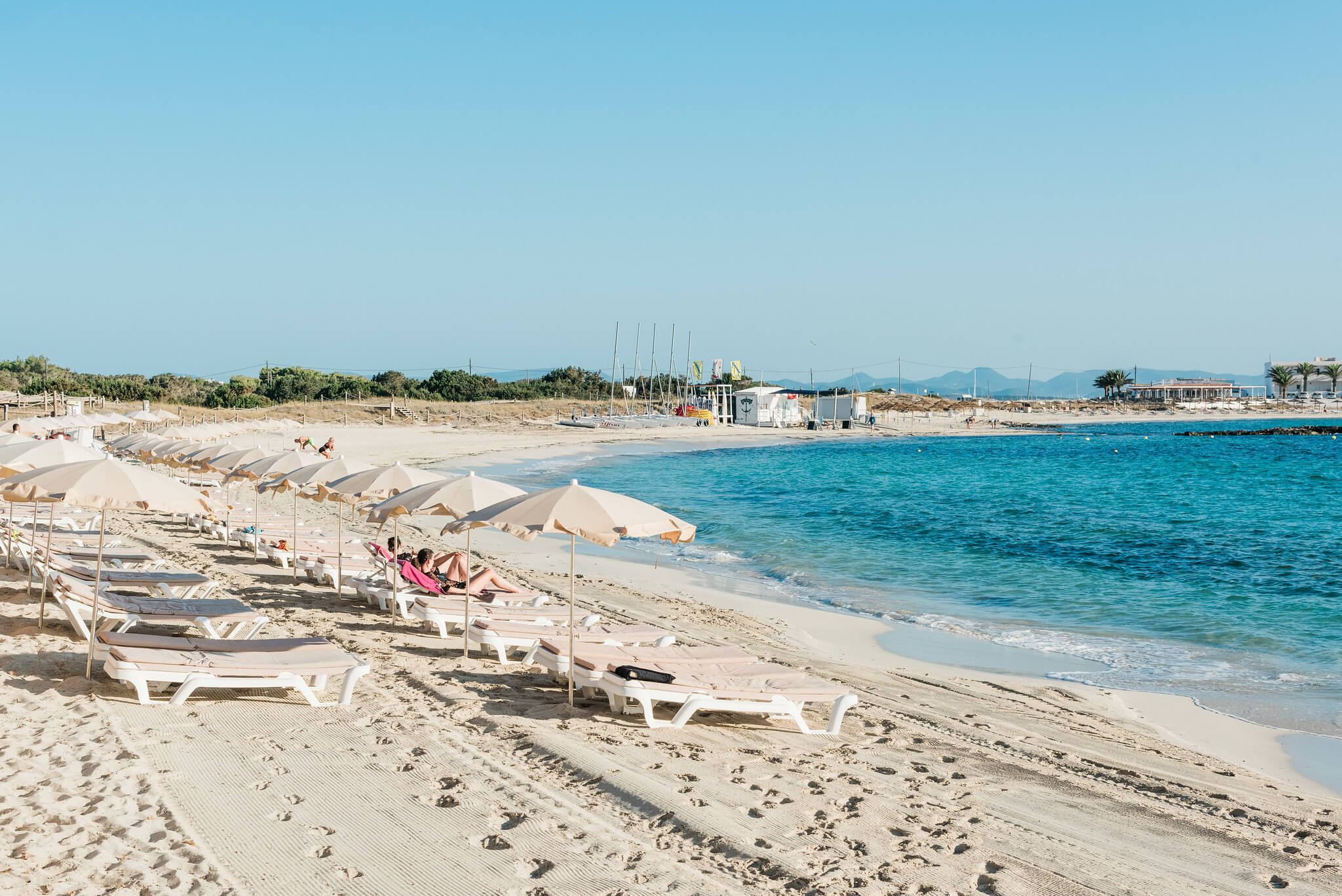 Es-Pujols-Beach-Formentera-sunbeds-water-blue