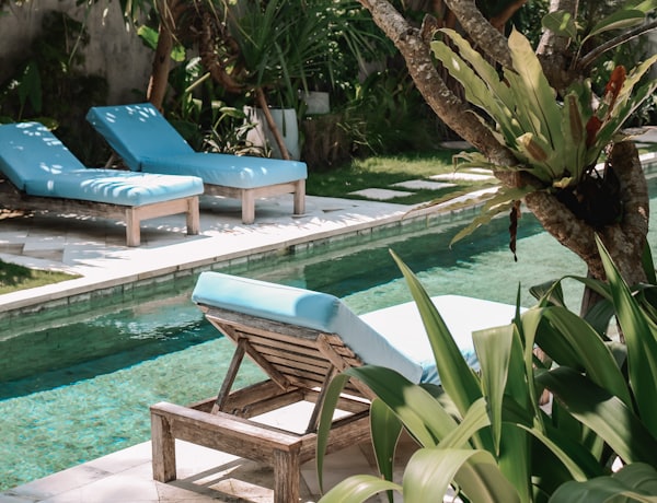 Sun loungers beside the pool of a holiday villa