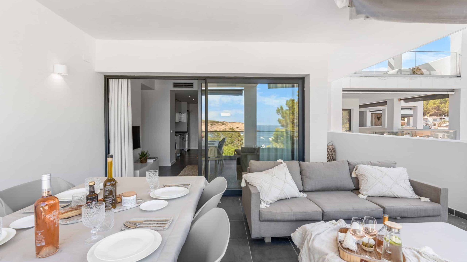 Open-plan living and dining room with sliding doors onto the terrace