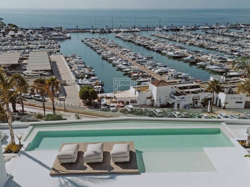 Communal rooftop swimming pool with panoramic marina views in Santa Eulària, Ibiza