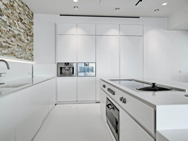 Minimalist white kitchen inside a modern villa in Can Furnet