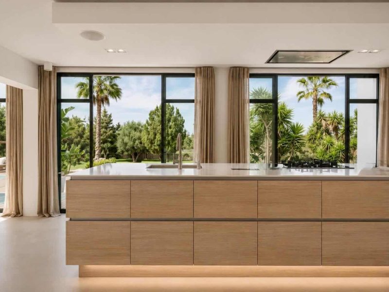 Contemporary kitchen with large windows overlooking the garden