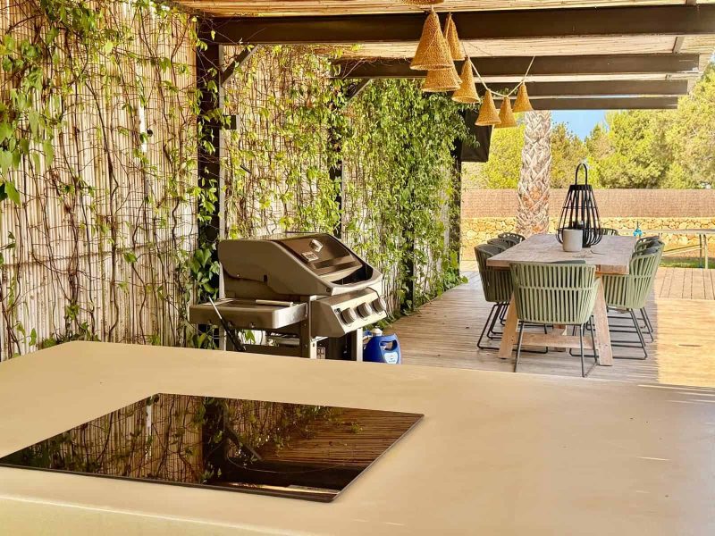 Covered outdoor kitchen and barbecue area at the Cala Bassa villa