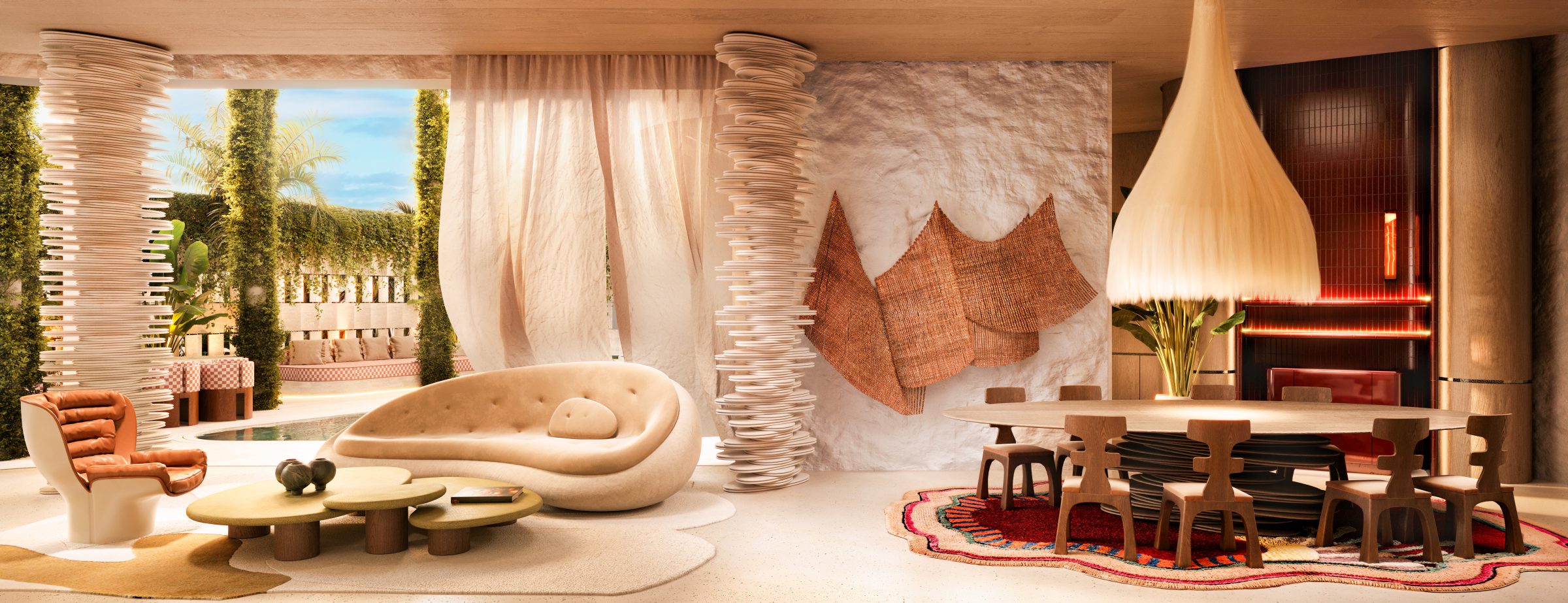 Living and dining room of the Casa Pacha garden villa, with sculptural furniture and a curved travertine bar