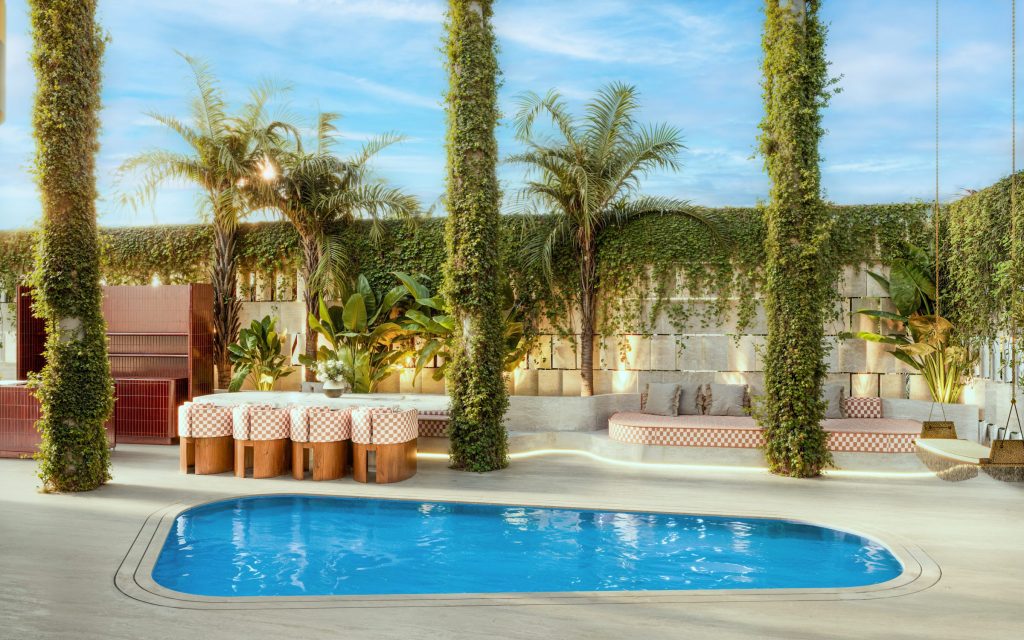 Private pool and garden terrace of the Casa Pacha garden villa, framed by palms