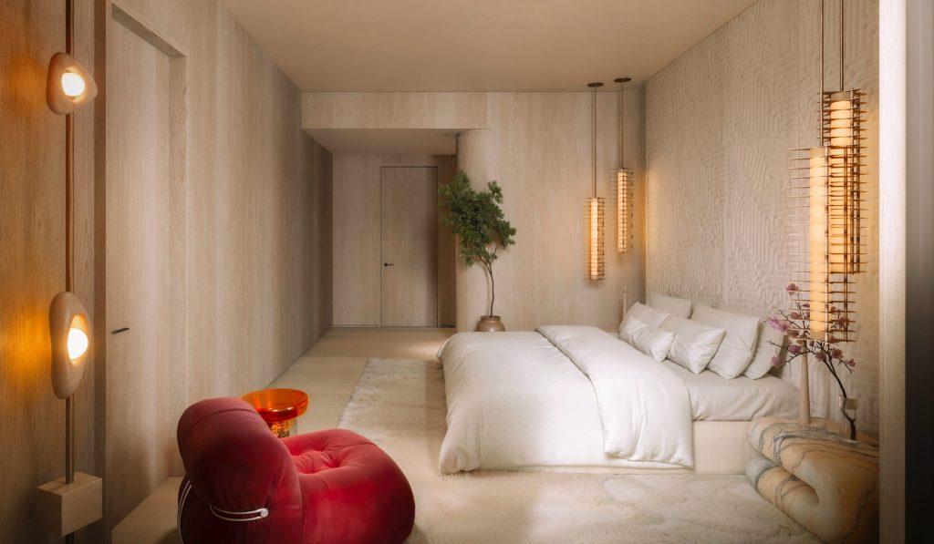 Casa Pacha penthouse bedroom with a dressing area and sculptural lighting