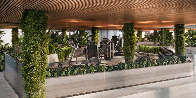 Gym at Casa Pacha Residences, with equipment set among planting under a timber ceiling