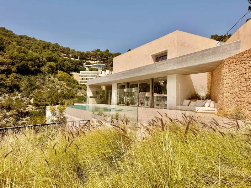 Modern architecture and landscaped hillside at Roca Llisa villa