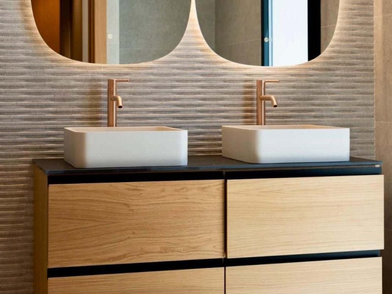 Bathroom with twin basins, oval mirrors and an oak vanity