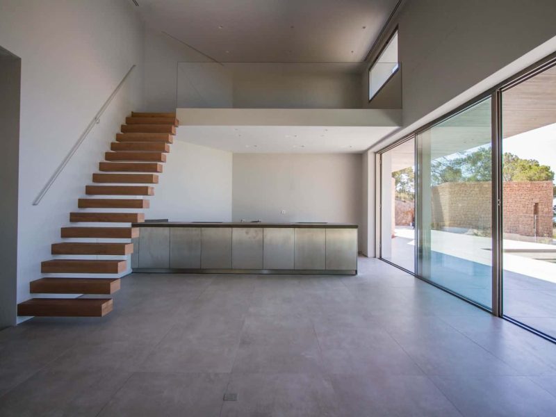 Modern 4-Bedroom Sea-View Villa in Roca Llisa, Ibiza, photo 7 Open-plan interior with floating staircase in Roca Llisa villa