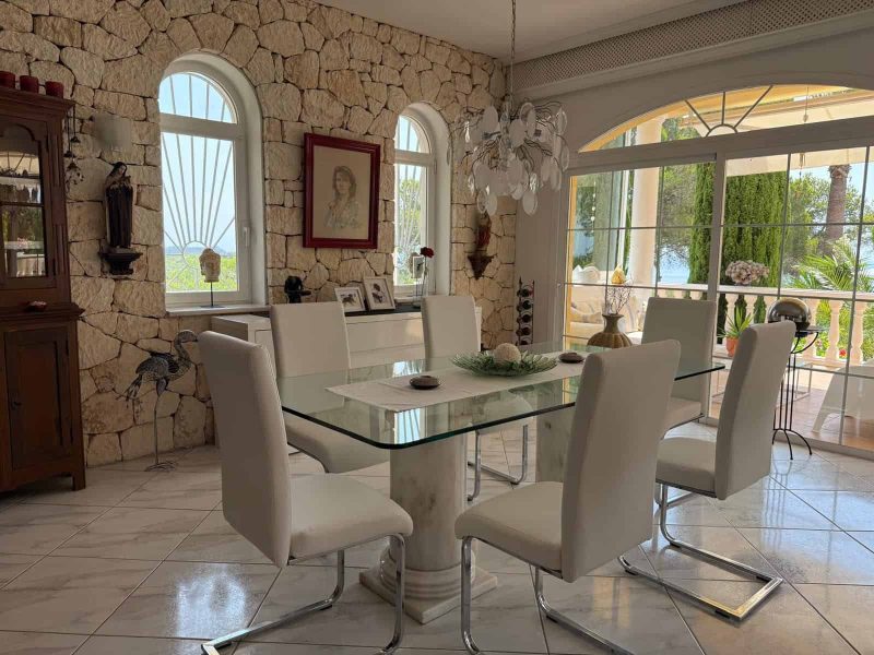 4-Bedroom Villa with Sea Views for Sale near San Carlos, Ibiza, photo 8 Dining room with natural stone wall and garden views